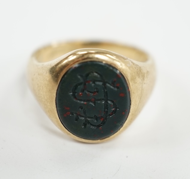 A 9ct gold and bloodstone set signet ring, with carved initial and interior inscription, size J/K, gross weight 5.9 grams. Condition - poor